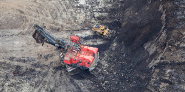 A large power shovel excavates heavy oil loaded sand from a Alberta Oilsands open pit mine near Fort McMurray.