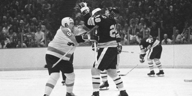 Philadelphia Flyers Andre Dupont (6), left, and Boston Bruins Mike Milbury (28), right, tangle during a fight in semifinal Stanley Cup hockey play in Philadelphia on Thursday, April 29, 1976. Both were penalized for fighting. (AP Photo/Rusty Kennedy)