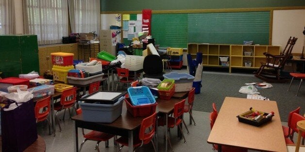 A teacher sets up an elementary school classroom in Surrey, B.C. in 2014.