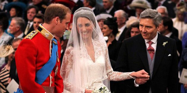 LONDON, ENGLAND - APRIL 29: Prince William speaks to his bride, Catherine Middleton as she holds the hand of her father Michael Middleton at Westminster Abbey on April 29, 2011 in London, England. The marriage of Prince William, the second in line to the British throne, to Catherine Middleton is being held in London today. The marriage of the second in line to the British throne is to be led by the Archbishop of Canterbury and will be attended by 1900 guests, including foreign Royal family members and heads of state. Thousands of well-wishers from around the world have also flocked to London to witness the spectacle and pageantry of the Royal Wedding. (Photo by Dominic Lipinski - WPA Pool/Getty Images)