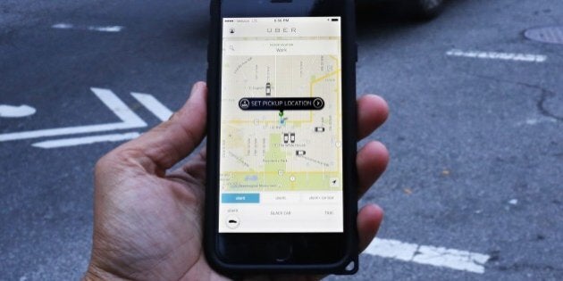 An UBER application is shown as cars drive by in Washington, DC on March 25, 2015. Uber said it was ramping up safety in response to rape allegations against a driver in India and growing concerns about background checks for operators of the popular ride-sharing service. In other cities where Uber operates, critics had complained that a lack of licensing and background checks of drivers could imperil those who use the service. AFP PHOTO/ ANDREW CABALLERO-REYNOLDS (Photo credit should read Andrew Caballero-Reynolds/AFP/Getty Images)