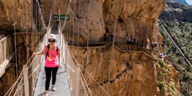 MALAGA, SPAIN - APRIL 01: Tourists walk along the 'El Caminito del Rey' (King's Little Path) footpath on April 1, 2015 in Malaga, Spain. 'El Caminito del Rey', which was built in 1905 and winds through the Gaitanes Gorge, reopened last weekend after a safer footpath was installed above the original. The path, known as the most dangerous footpath in the world, was closed after two fatal accidents in 1999 and 2000. The restoration started in 2011 and reportedly cost 5.5 million euros. (Photo by David Ramos/Getty Images)