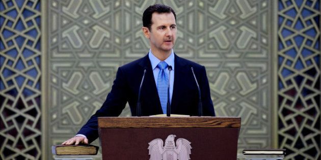 In this Wednesday July 16, 2014 photo, and released by the Syrian official news agency SANA, Syria's President Bashar Assad is sworn for his third, seven-year term, in Damascus, Syria. Proclaiming the Syrian people winners in a