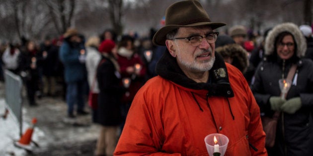 MONTREAL, CANADA - DECEMBER 6: Canadian people light candle as they take part in a ceremony at Notre-Dame de Neiges cemetery to mark the 25th anniversary of the Ecole Polytechnique massacre in Montreal, Canada on December 6, 2014. 25 years to the day, 25-year-old Marc Lepine killed 14 women at the Ãcole Polytechnique because of their gender. (Photo by Amru Salahuddien/Anadolu Agency/Getty Images)