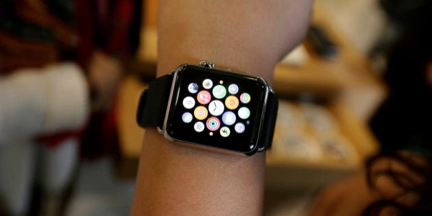 A person poses with an Apple Watch for a picture in a store on Oxford Street in London, Friday, April 10, 2015. The technology company's latest product is on display in the store ahead of its full release for sale on April 24. (AP Photo/Tim Ireland)