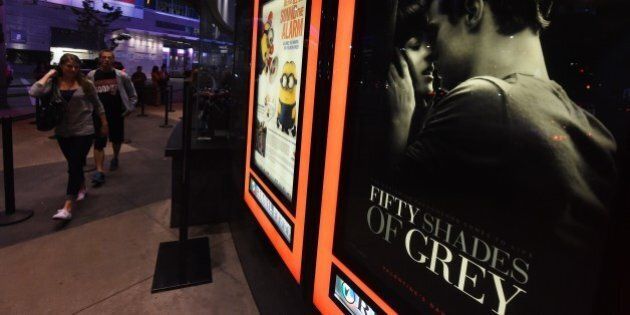 People arrive to watch the film 'Fifty Shades of Grey' on its opening day in Los Angeles on February 12, 2015. 'Fifty Shades of Grey', the long-anticipated movie version of the bestselling erotic novel, began its worldwide rollout opening in theatres across France, Germany, Belgium and Serbia, days ahead of its key target territory the United States. AFP PHOTO/Mark RALSTON, Germany, Belgium and Serbia, days ahead of its key target territory the United States. AFP PHOTO/Mark RALSTON (Photo credit should read MARK RALSTON/AFP/Getty Images)