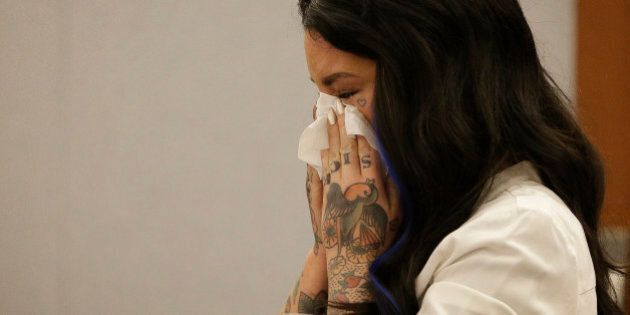 Christine Mackinday, also known as Christy Mack, cries on the witness stand during a preliminary hearing for Jonathan Paul Koppenhaver, also known as War Machine, Friday, Nov. 14, 2014, in Las Vegas. Koppenhaver is accused of assaulting his former girlfriend Mackinday. (AP Photo/John Locher)