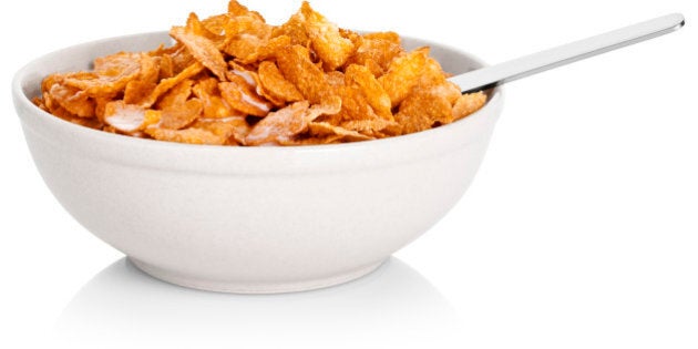 Bowl of corn flakes cereal, on white background, cut out