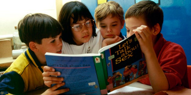 Sex education in primary school. 8 & 9 year olds reading Let's Talk About Sex book, London Borough of Greenwich UK. (Photo by: Photofusion/UIG via Getty Images)