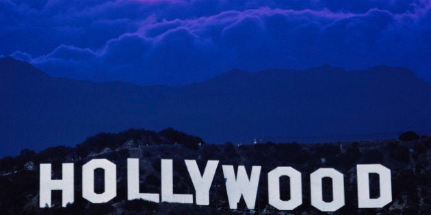 USA, California, Los Angeles, sun behind clouds over Hollywood sign