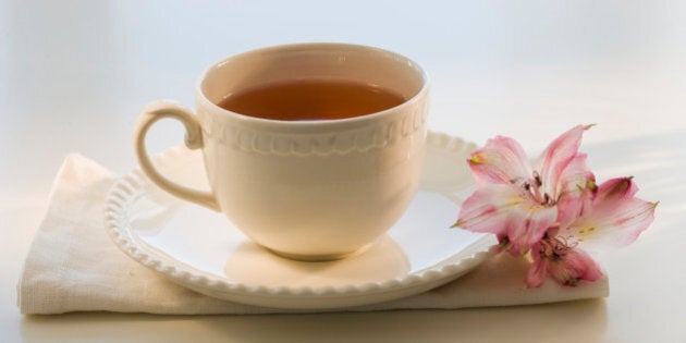 Cup of tea on cloth with flower