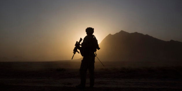 A soldier with the Canadian Army's 1st Battalion 22nd Royal Regiment prepares for an operation at sunrise Monday, June 27, 2011 in the Panjwaii district of Kandahar province, Afghanistan. Canadian combat operations will end in July as troops withdraw from the southern region and hand control over to the Americans. Canada will transition to a non-combat training role with up to 950 soldiers and support staff to train Afghan soldiers and cops in areas of the north, west and Kabul. (AP Photo/David Goldman)