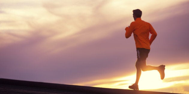 Male runner silhouette, Man running into sunset, colorful sunset sky