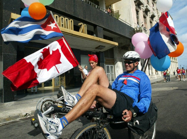 A father and his daughter ride through Prado Boulevard while participating in the 7th Terry Fox Marathon of Hope, in Havana, Feb. 8, 2004.