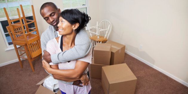Moving house. African American mid adult couple (30s) moving into new home.