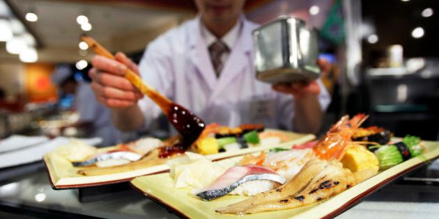 A Kiyomura K.K. sushi chef prepares plates of various sushi at a Sushi Zanmai sushi restaurant in Tokyo, Japan, on Sunday, Jan. 5, 2014. Kiyomura is a Tokyo-based sushi chain operator. Photographer: Kiyoshi Ota/Bloomberg via Getty Images
