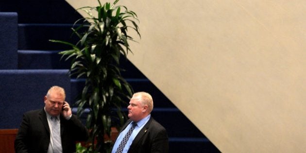 TORONTO, ON - NOVEMBER 15 - Toronto City Councillor Doug Ford stands with his brother Toronto Mayor Rob Ford during a city hall meeting November 15, 2013. (Carlos Osorio/Toronto Star via Getty Images)