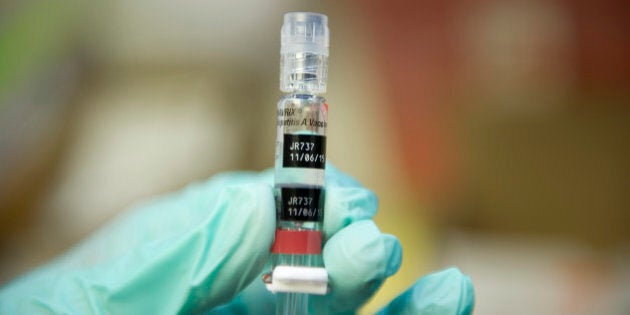 A nurse loads a syringe with a vaccine against hepatitis at a free immunization clinic for students before the start of the school year, in Lynwood, California August, 27, 2013. Nurses are immunizing children in preparation for the first day of public school on September 3. The clinic offers the mandatory vaccinations for school children against diphtheria, tetanus, pertussis, polio, hepatitis B, MMR (measles, mumps, rubella) and chickenpox as well as some optional ones. AFP PHOTO / Robyn Beck (Photo credit should read ROBYN BECK/AFP/Getty Images)