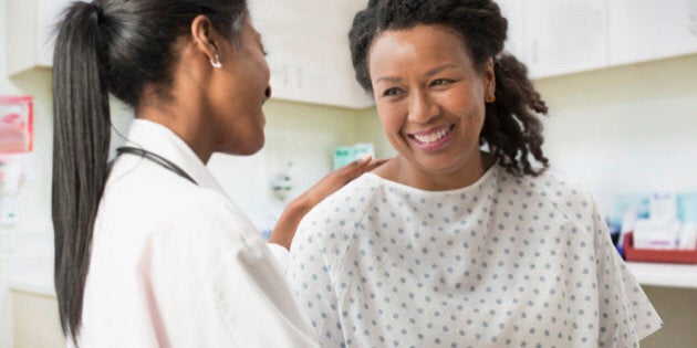 Doctor comforting patient in office