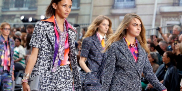 Model Cara Delavingne, right, and other models wear creations as part of Chanel's Spring/Summer 2015 ready-to-wear fashion collection presented in Paris, France, Tuesday, Sept. 30, 2014. (AP Photo/Thibault Camus)