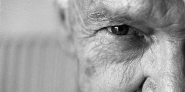 Senior man looking at camera, close-up, cropped
