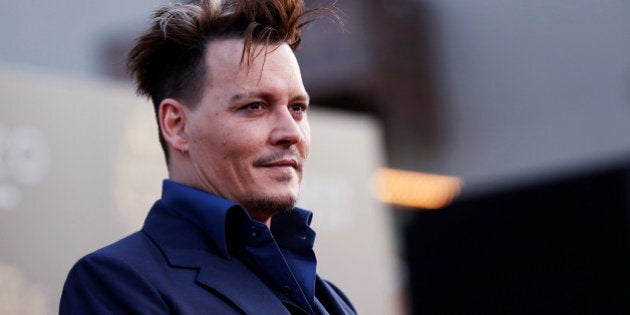 Cast member Johnny Depp poses at the premiere of