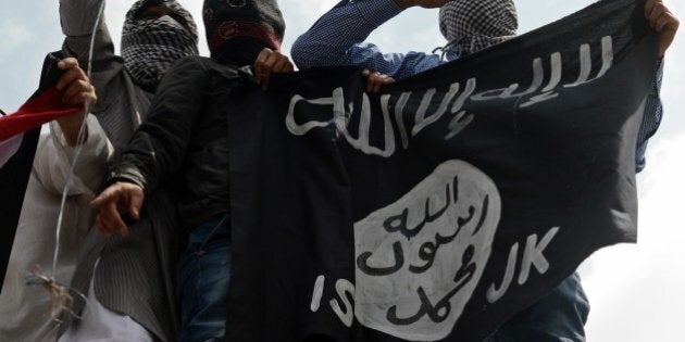 Kashmiri demonstrators hold up a flag of the Islamic State of Iraq and the Levant (ISIL) during a demonstration against Israeli military operations in Gaza, in downtown Srinagar on July 18, 2014. The death toll in Gaza hit 265 as Israel pressed a ground offensive on the 11th day of an assault aimed at stamping out rocket fire, medics said. AFP PHOTO/Tauseef MUSTAFA (Photo credit should read TAUSEEF MUSTAFA/AFP/Getty Images)