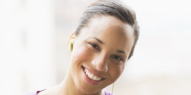 Portrait of female jogger with mp3 player