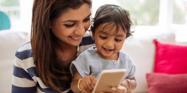 Indian mother and child playing game on the smartphone