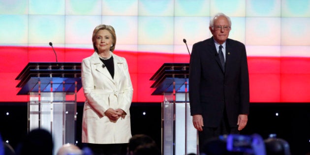 Democratic U.S. presidential candidate Hillary Clinton and Senator Bernie Sanders (R) stand together at the start of their Democratic debate hosted by CNN and New York One at the Brooklyn Navy Yard in New York April 14, 2016. REUTERS/Lucas Jackson