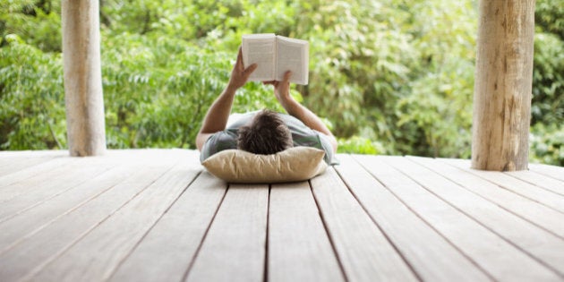 Man reading on porch in remote area