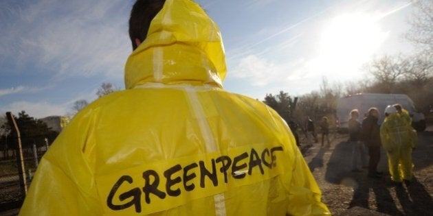 A Greenpeace militant looks towards a reactor of the nuclear power plant of Fessenheim on which Greenpeace hung a banner reading 'Stop risking Europe' on March 18, 2014. Several dozen Greenpeace activists snuck into a nuclear power plant in eastern France on Tuesday, in the latest break-in by the environmental group aimed at highlighting alleged security weaknesses at atomic facilities. AFP PHOTO / SEBASTIEN BOZON (Photo credit should read SEBASTIEN BOZON/AFP/Getty Images)