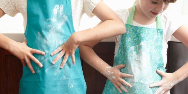 kids wiping flour onto their aprons