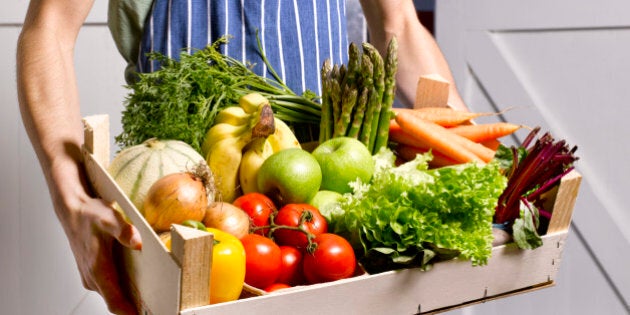 Man delivering fruit and vegetable box.