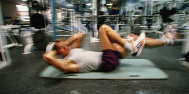 Man exercising in gym (blurred motion)