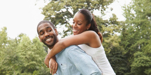 Husband and wife playing in park