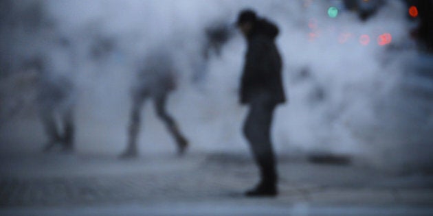 man crossing steam on downtown toronto