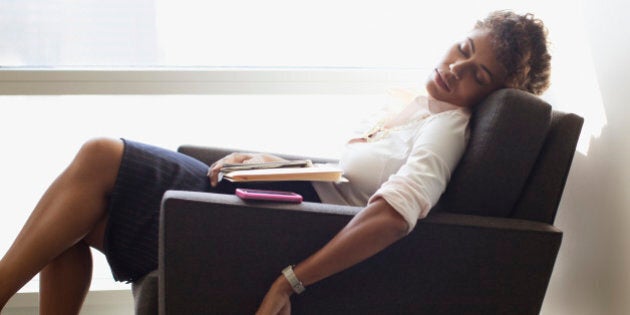 Businesswoman sleeping in office chair