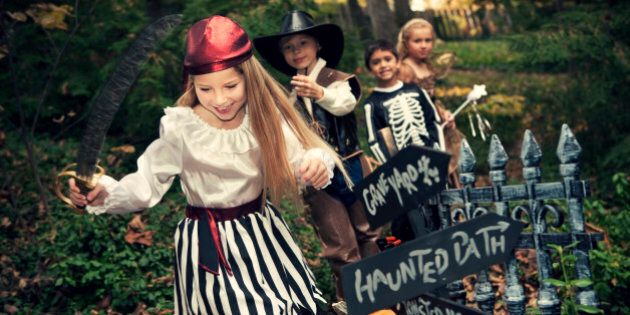 Photo series with a group of children enjoying a haunted Halloween path in the woods.