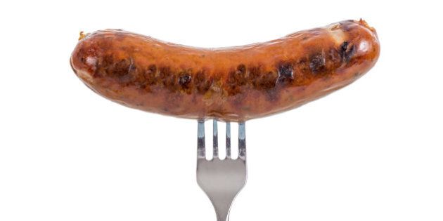 Grilled Sausage on a fork isolated on white background