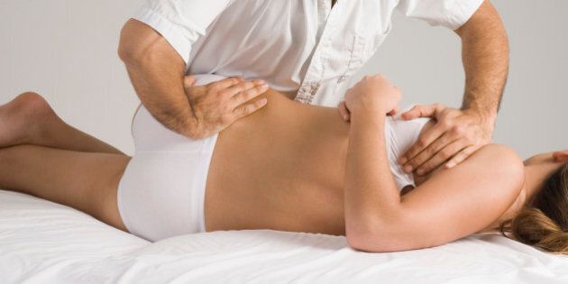 Chiropractor adjusting woman's back