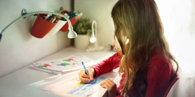 Blond girl painting in her room