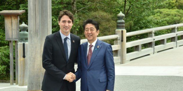 ISE, JAPAN - MAY 26: Japanese Prime Minister Shinzo Abe (R) and Canadian Prime Minister Justin Trudeau (L) shake hands prior to G7 leaders summit at the Ise Jingu (Shrine) on May 26, 2016 in Ise, Mie Prefecture, Japan. (Photo by Ministry of Foreign Affairs of Japan / Handout /Anadolu Agency/Getty Images)