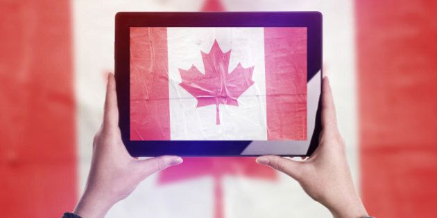 Person Taking Picture of Canada Flag with Digital Tablet Computer, Vintage Tone Retro Effect