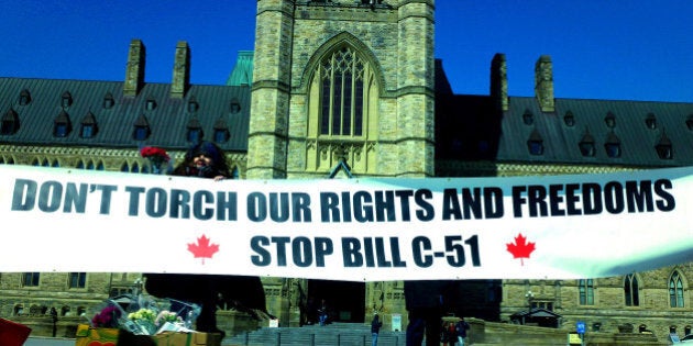 Toronto activists remind Canadians that Harper's proposed anti-terror Bill C-51 will torch rights and freedoms protected by the Charter during a protest on Parliament Hill, Ottawa, on Monday, March 23, 2015. Photo: OBERT MADONDO/The Canadian Progressive