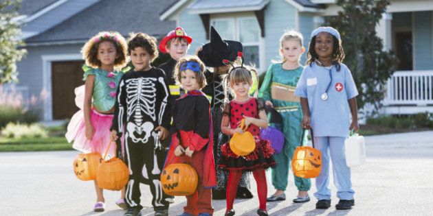 Multi-ethnic group of children 3-6 years old, wearing halloween costumes.