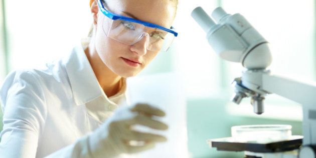 Serious female chemist working in laboratory