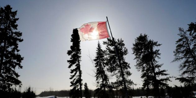 A Canadian flag flies over the Berens River in Berens River, Manitoba, Canada, on Thursday, Feb. 14, 2013. About 1.3 million Canadian aboriginals, the youngest and fastest-growing segment of Canadaâs population, are struggling to reverse centuries of oppression and modern-day neglect. Photographer: Marc Rochette/Bloomberg via Getty Images