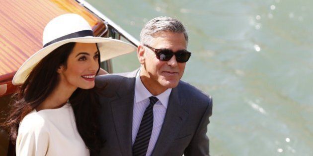US actor George Clooney and British lawyer Amal Alamuddin leave the palazzo Ca Farsetti on a taxi boat on September 29, 2014 in Venice, after a civil ceremony to officialise their wedding. AFP PHOTO / PIERRE TEYSSOT (Photo credit should read PIERRE TEYSSOT/AFP/Getty Images)