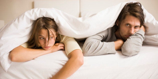 Sick couple resting in bed